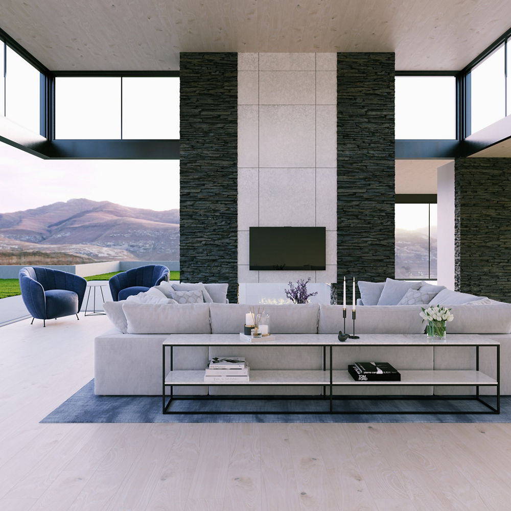 a modern living room with a sectional couch, blue rug, white quartz floor-to-ceiling fireplace, and light stained wooden floors. 