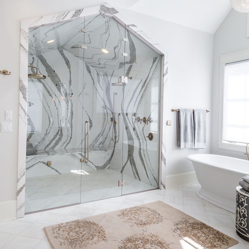 Bathroom featuring a shower with Cambria Annicca quartz surfaces on the walls and bench of the shower.