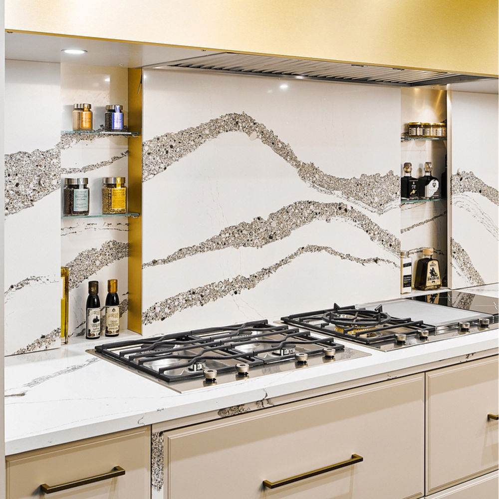 Kitchen with a counter and stove featuring a Cambria Annicca quartz backsplash.