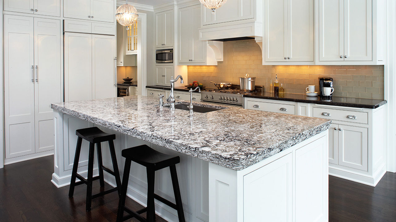Kitchen featuring an island with a marble-like dark gray and black tones with a Cambria Bellingham quartz countertop.