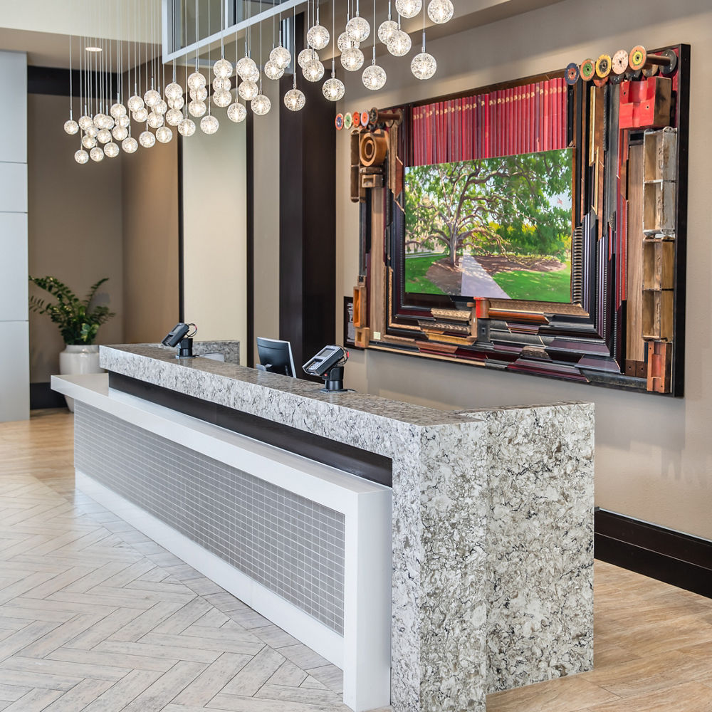 A gorgeous lobby at the Embassy Suites, College Station with a reception desk made from quartz.
