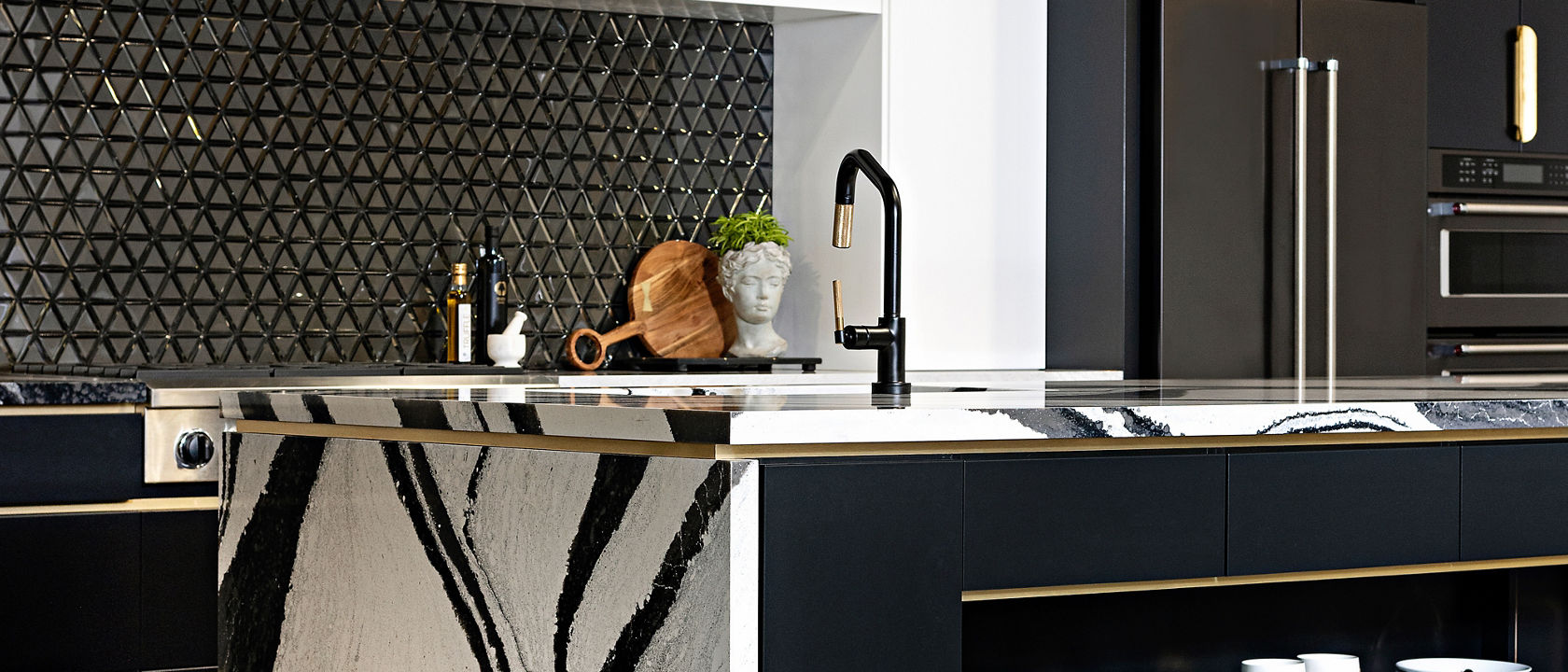 Kitchen featuring a counter and island with Cambria Bentley quartz countertops.