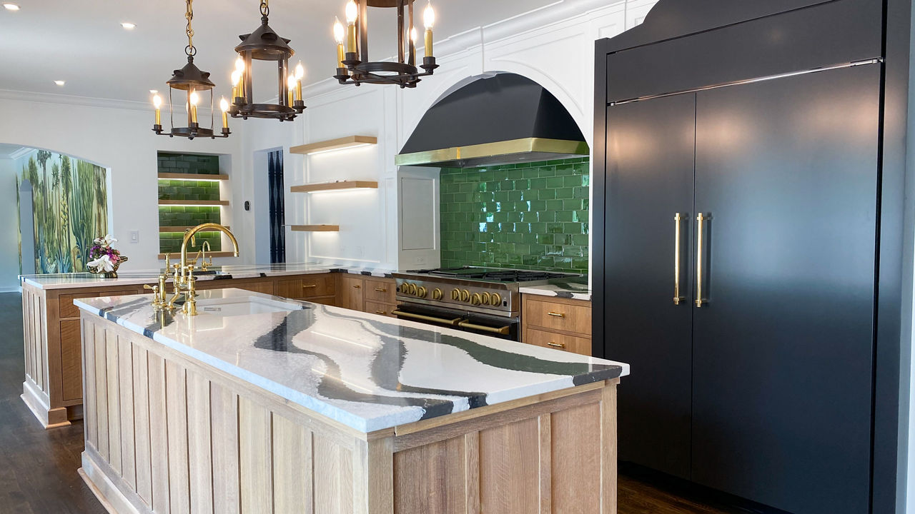 Kitchen featuring a green backsplash and a kitchen island with Cambria Bentley quartz countertops.