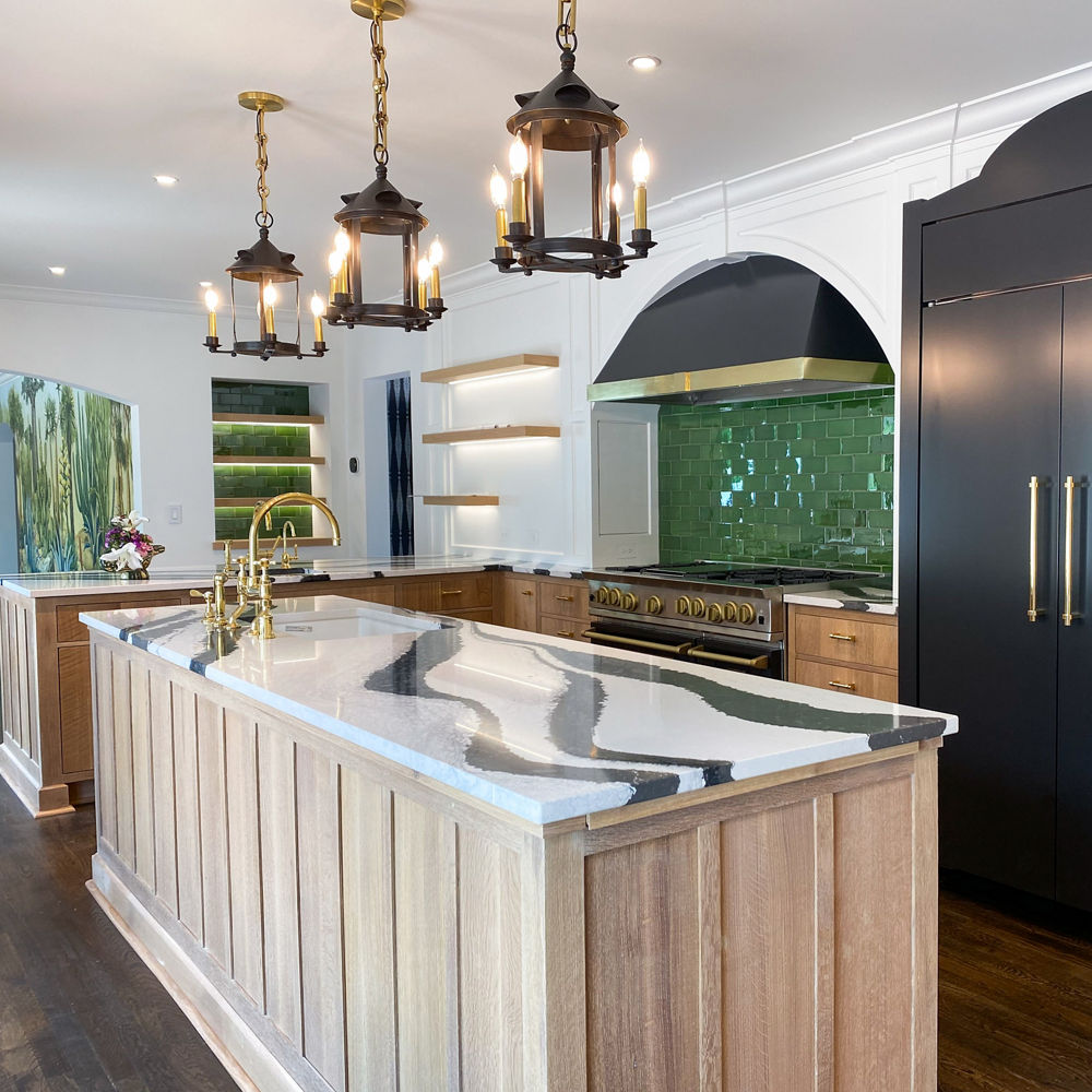 Kitchen featuring a green backsplash and a kitchen island with Cambria Bentley quartz countertops.