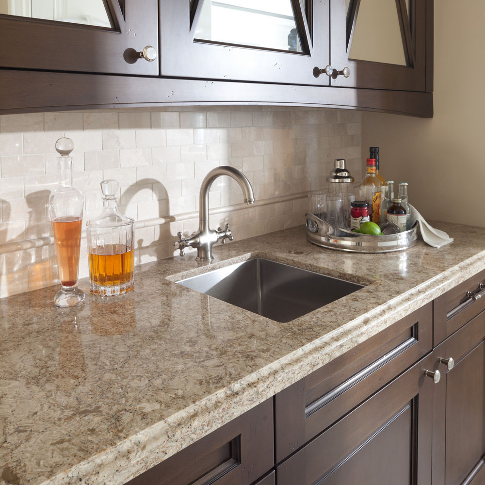 Rich oaken wood cabinets accented by a Cambria Berkeley Bar quartz countertop