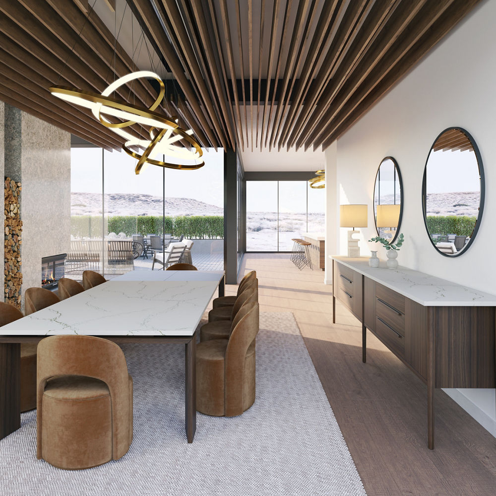 Dining room featuring table with a Cambria Berkshire Brass quartz countertop surrounded by brown round chairs.