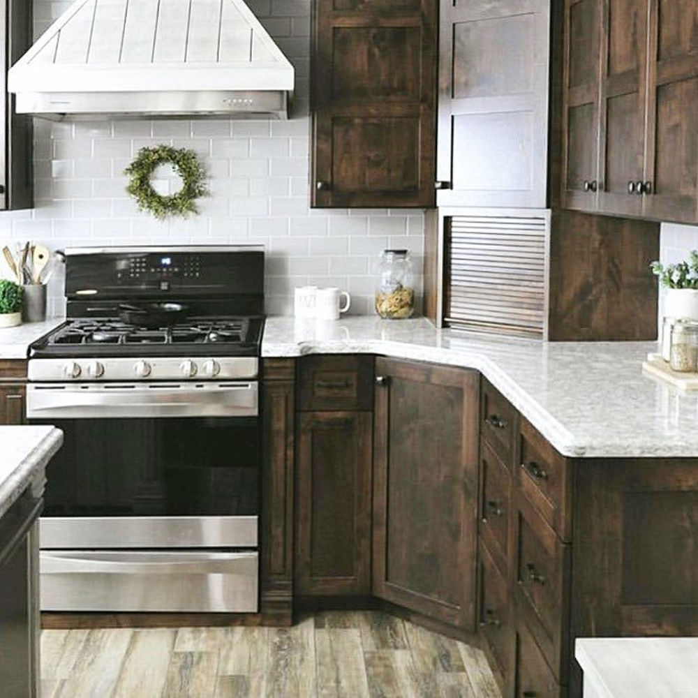 Kitchen with dark wood cabinets and Cambria Berwyn quartz countertops.