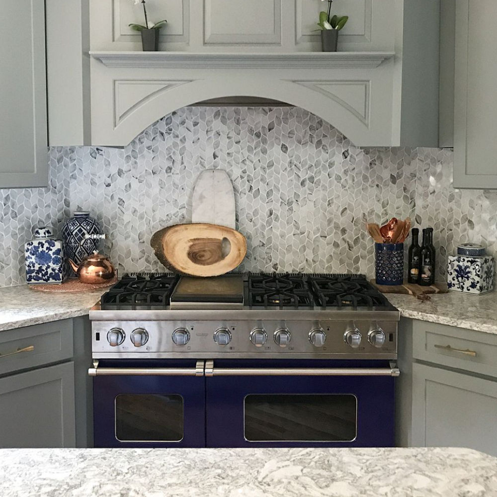 Gray kitchen featuring blue appliances and Berwyn Matte countertops focused on stove.