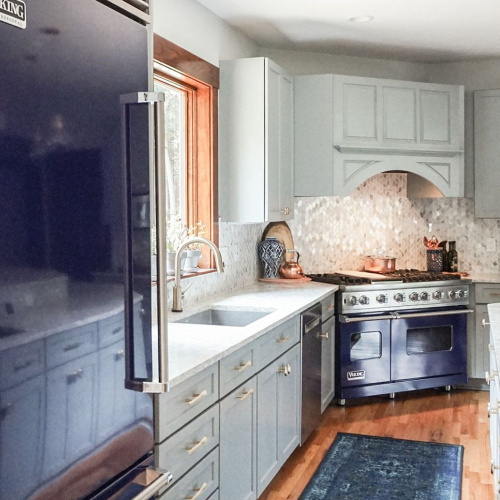 Gray kitchen featuring blue appliances and Berwyn Matte countertops focused on refrigerator.