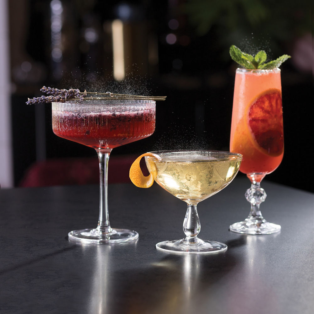 Three drinks in glasses on a Cambria Black Rock Matte quartz counter.