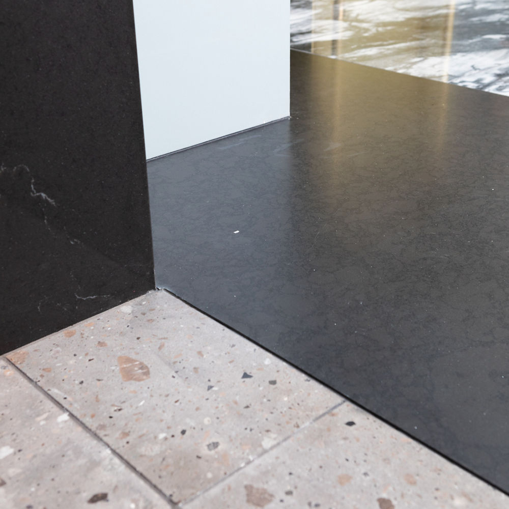 Black Rock Matte quartz flooring pairs nicely with white and black walls.