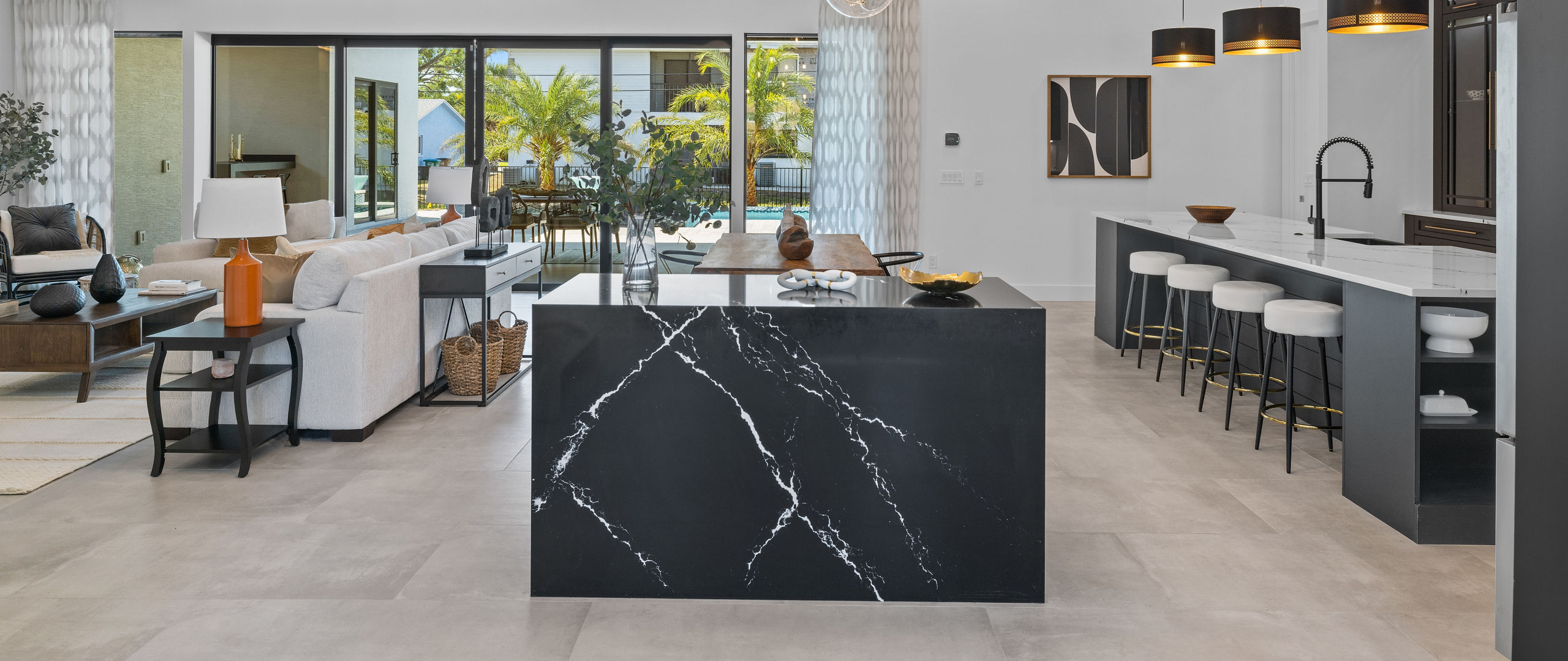 An open kitchen with a counter featuring Cambria Blackbrook quartz.