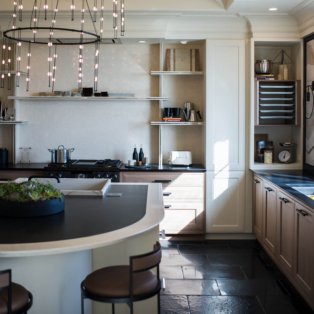 Kitchen with a focus on the island and oven across from each other.