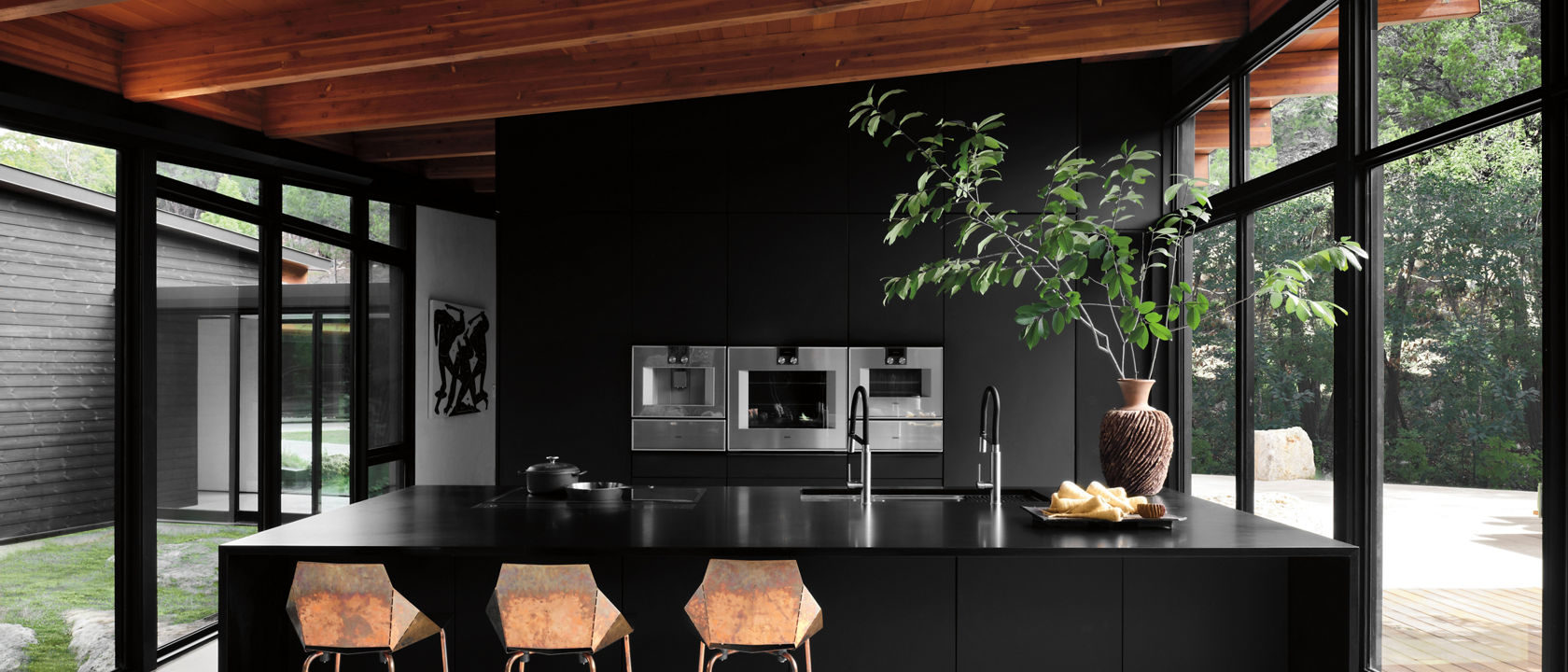 Rich black and brown kitchen featuring Cambria Blackpool Matte