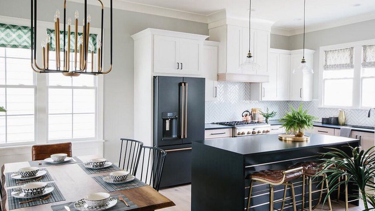 Kitchen featuring matte black fridge and island contrasting white cabinetry and walls.