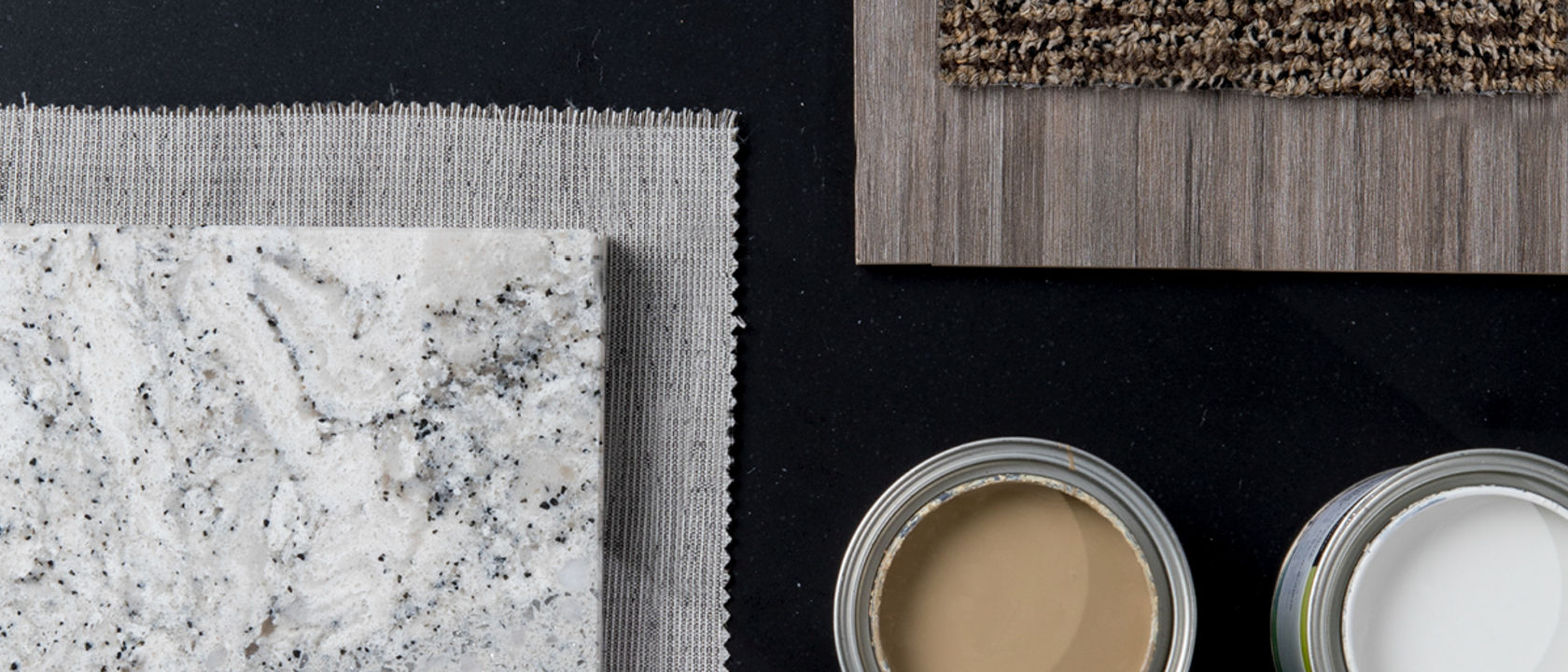 A moodboard featuring a Cambria Blackpool Matte quartz countertop with a wood panel, two candles, and a slab of Cambria Summerhill quartz over a gray cloth.