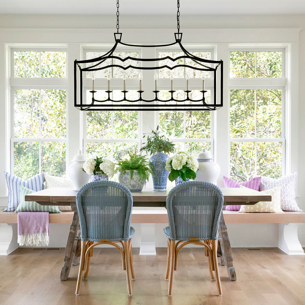 An open and airy dining room featuring the wood Olivia table