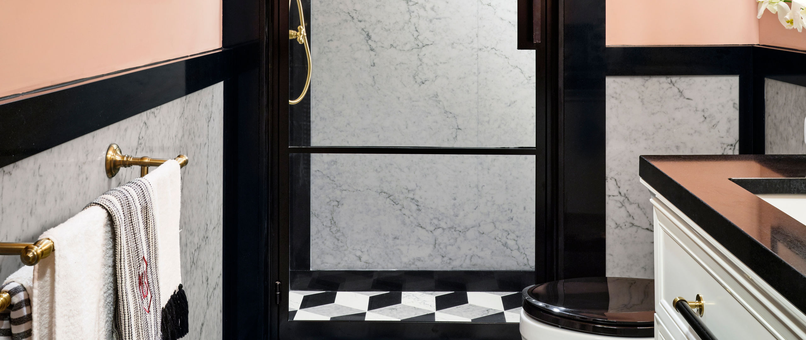 A sleek modern bathroom with Cambria Bridport shower walls and Cambria Black quartz countertop
