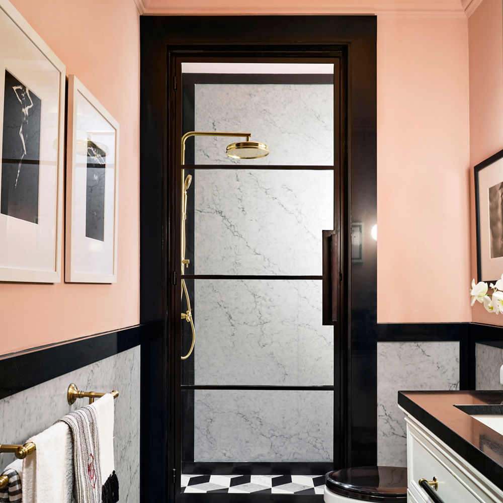 A sleek modern bathroom with Cambria Bridport shower walls and Cambria Black quartz countertop