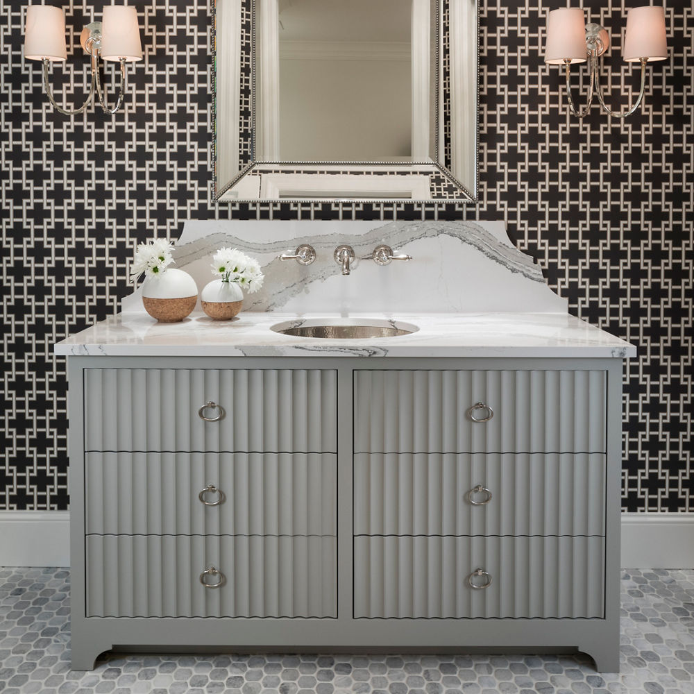 An elegant bathroom accented by an Cambria Brittanicca quartz countertop sink