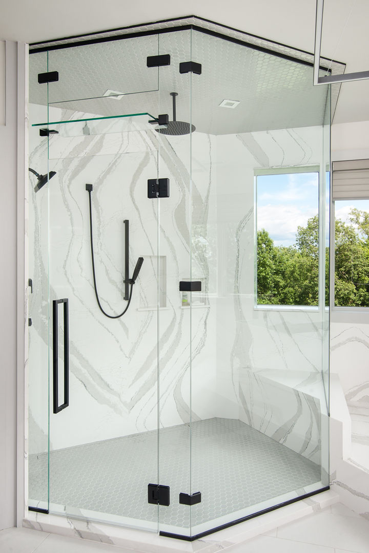 A full-height Cambria Brittanicca quartz wall siding provides a wall inside of a shower.