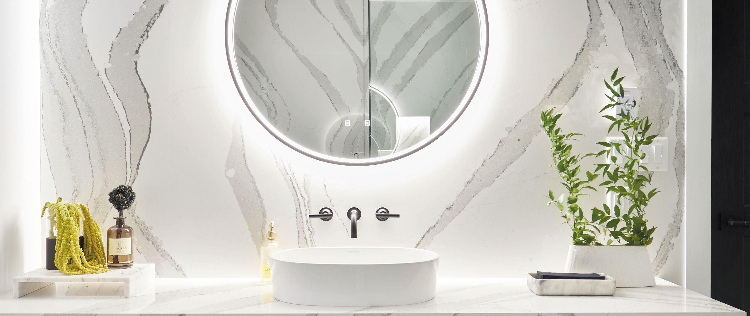 A bathroom with a Brittanicca quartz wall and vanity