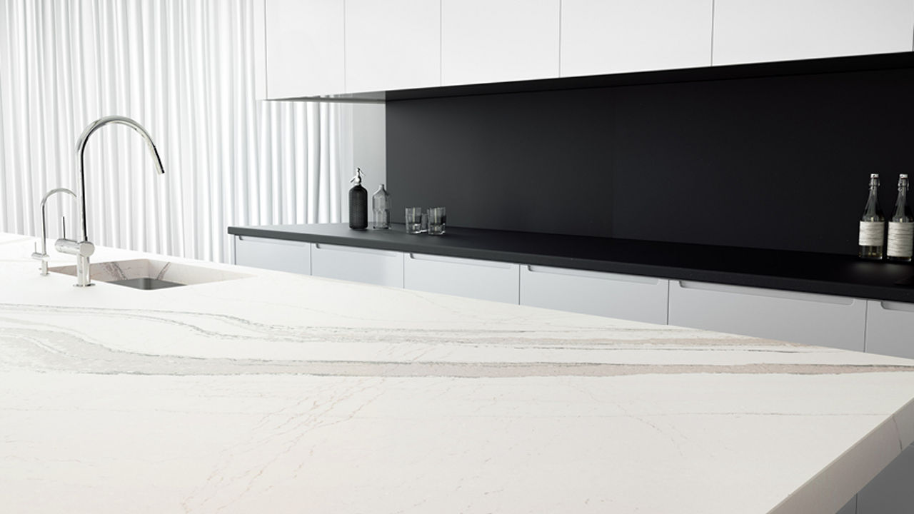 Kitchen island and backsplash with Cambria Brittanicca Matte and Cambria Black Matte quartz.