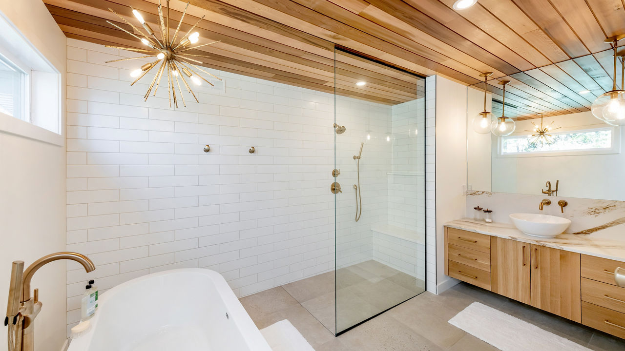 Bathroom featuring a shower and countertop with Cambria Brittanicca Gold Warm quartz.