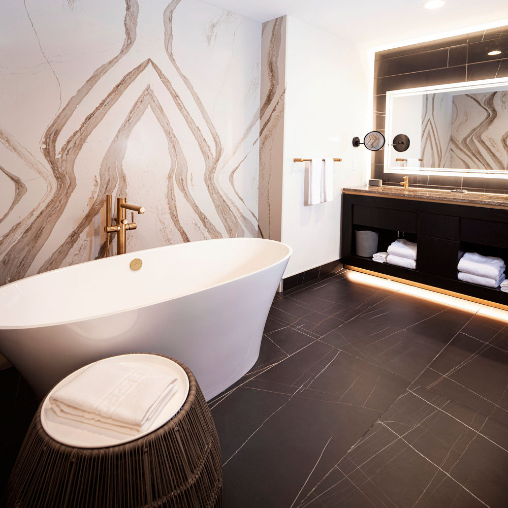 A guest bathroom featuring a wall with Cambria Brittanicca Gold Warm quartz.