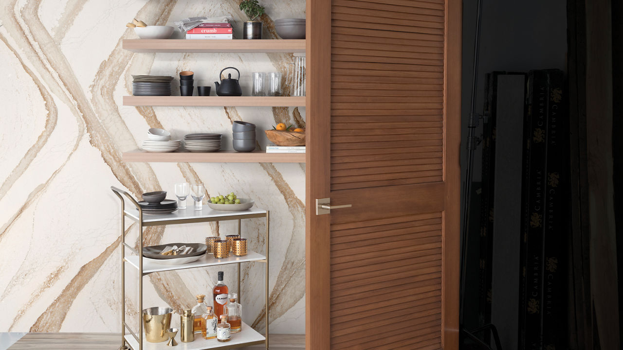 A shelf and a bar cart with a full height Brittanicca Gold Warm backsplash