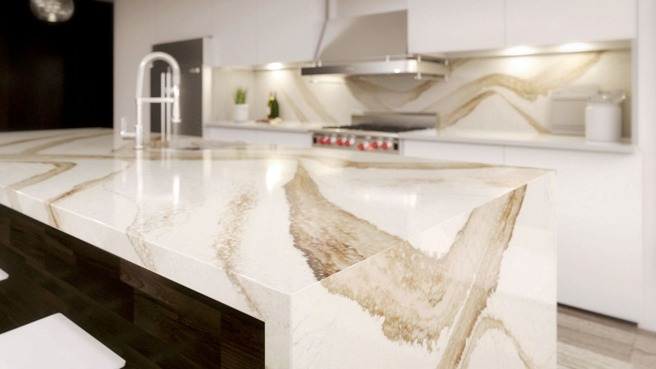 A kitchen with a close up view of a Brittanicca Gold Warm quartz countertop waterfall