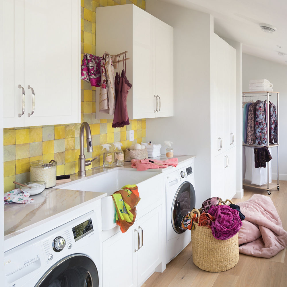 A homey laundry room with a farmhouse sink and Cambria Brittanicca Gold quartz countertop