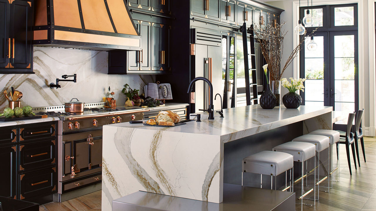 Kitchen featuring an island and siding with Cambria Brittanicca Gold Warm quartz countertops.