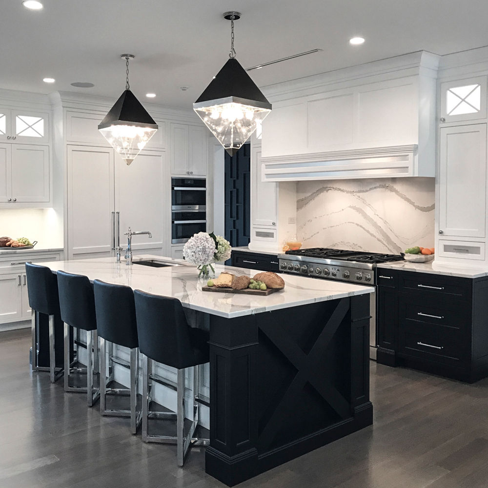 A black and white kitchen with black wood siding and Cambria Brittanicca quartz countertops.