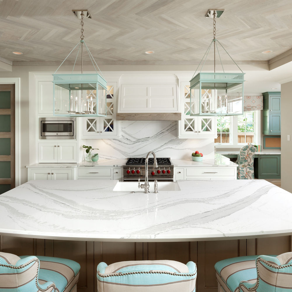 A kitchen island and backsplash featuring Cambria Brittanicca quartz.