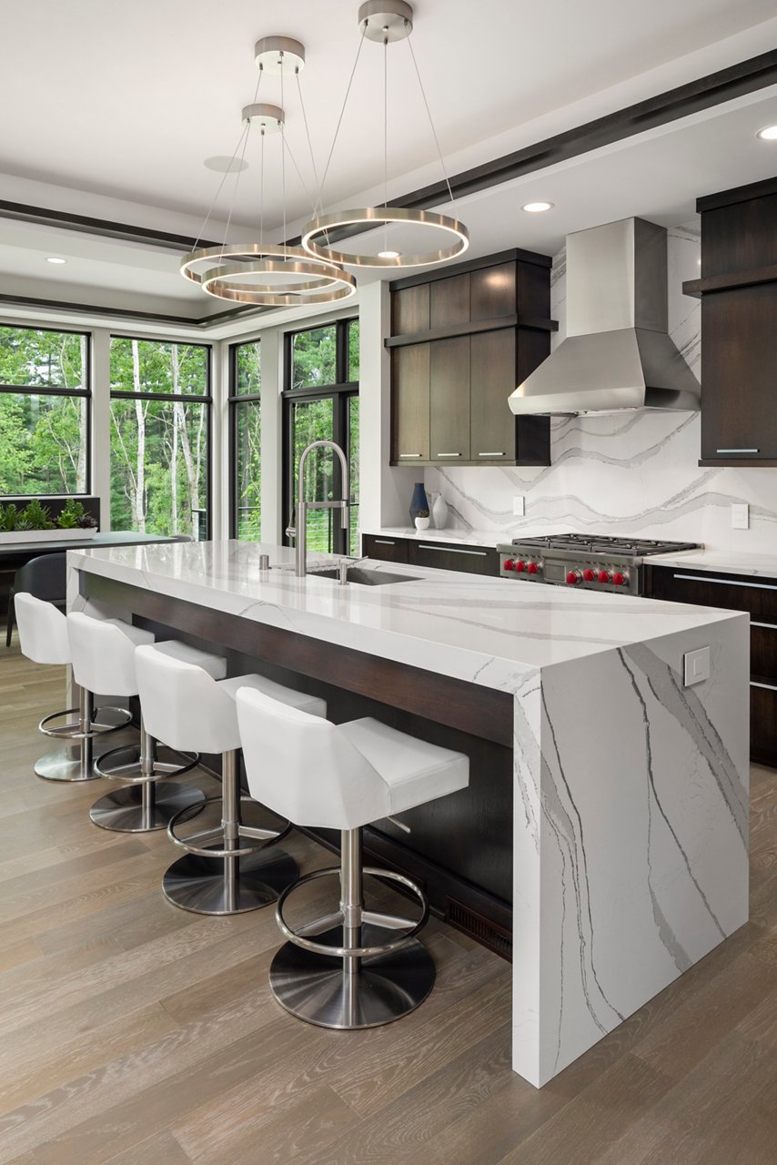 Kitchen featuring an island with Cambria Brittanica quartz siding and countertops.