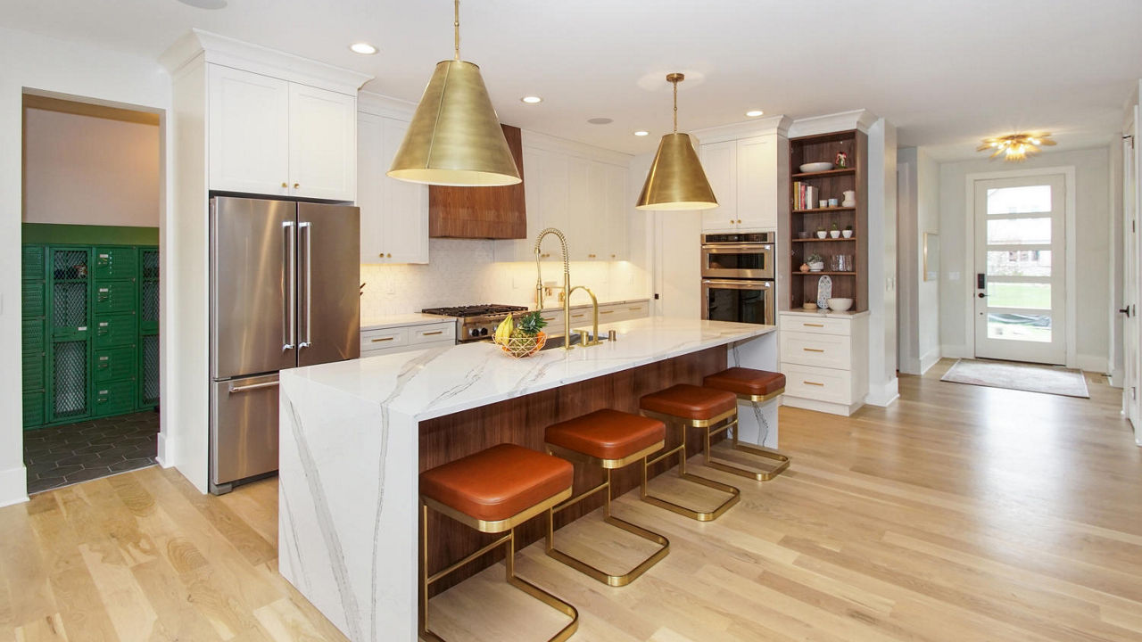 An elegant white and wood themed kitchen accented by Cambria Brittanicca quartz countertop