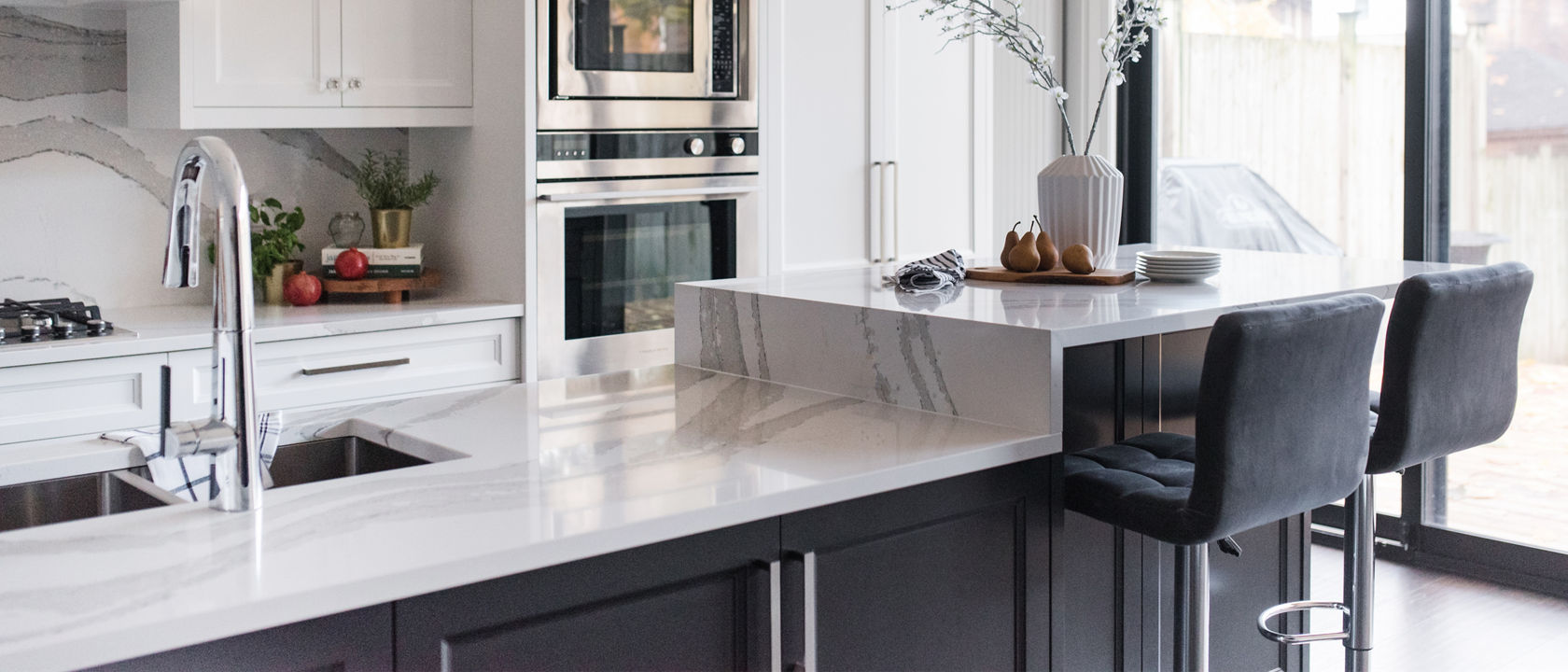 Kitchen featuring an island with Cambria Brittanicca quartz countertops.