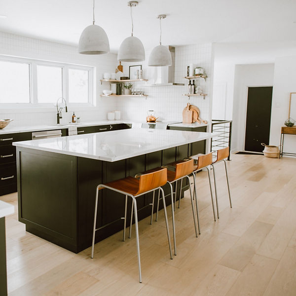 A cozy white kitchen with dark brown cabinets and Brittanicca quartz countertops by Jaclyn Peters