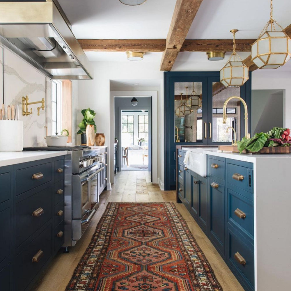 Photograph of kitchen focused on space between island and countertop facing wall.