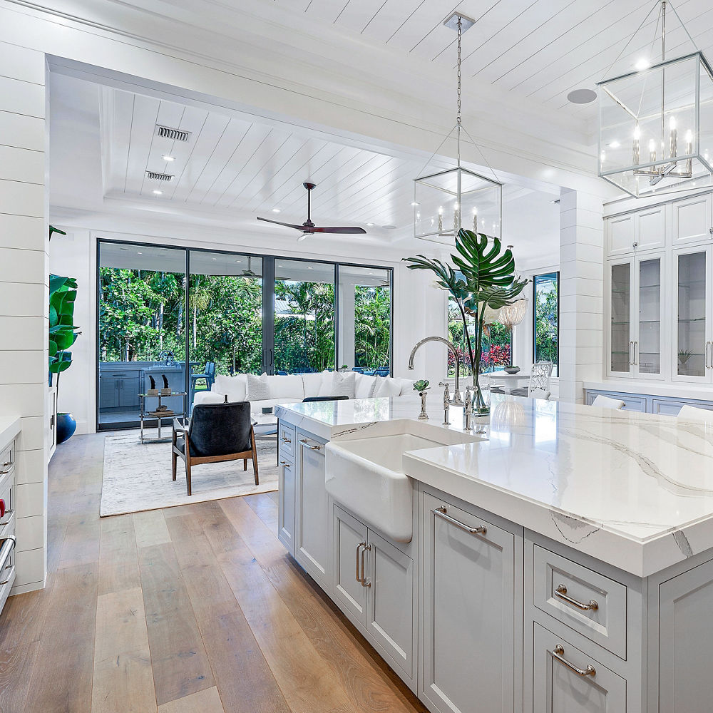 A kitchen with large windows and Brittanicca quartz countertops