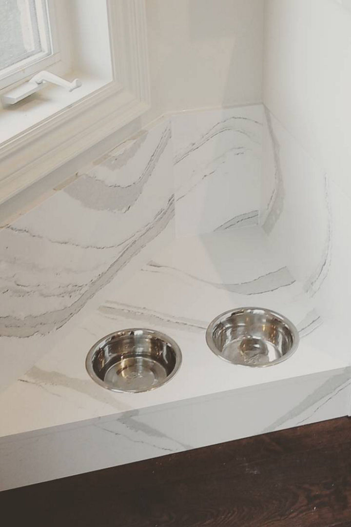 a pet feeding station made from white and gray veined quartz. 