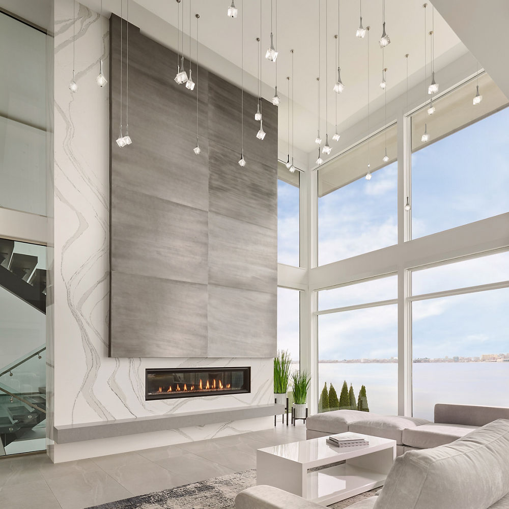 a luxurious, modern living room with a floor-to-ceiling white quartz fireplace.