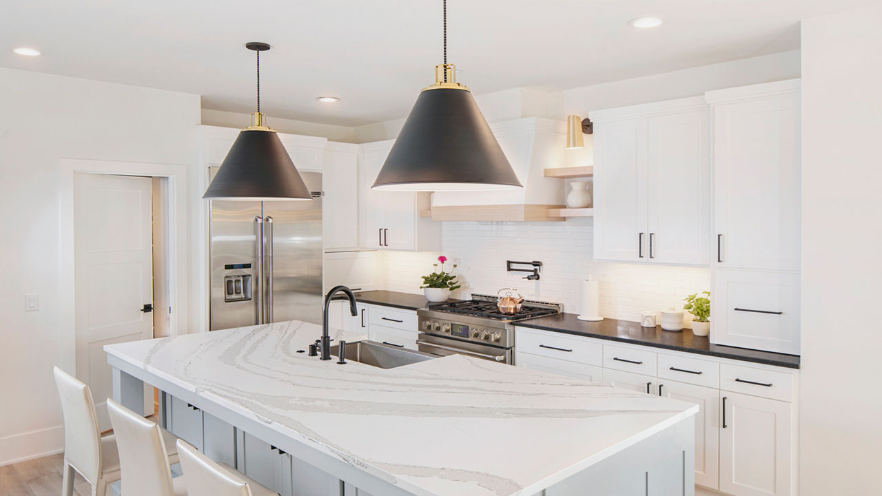 A bright, warm kitchen featuring an island with an anti-glare Cambria Matte quartz countertop.