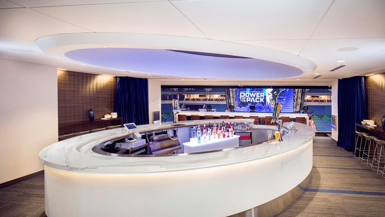 a rounded bar in Target Center featuring white quartz countertops. 