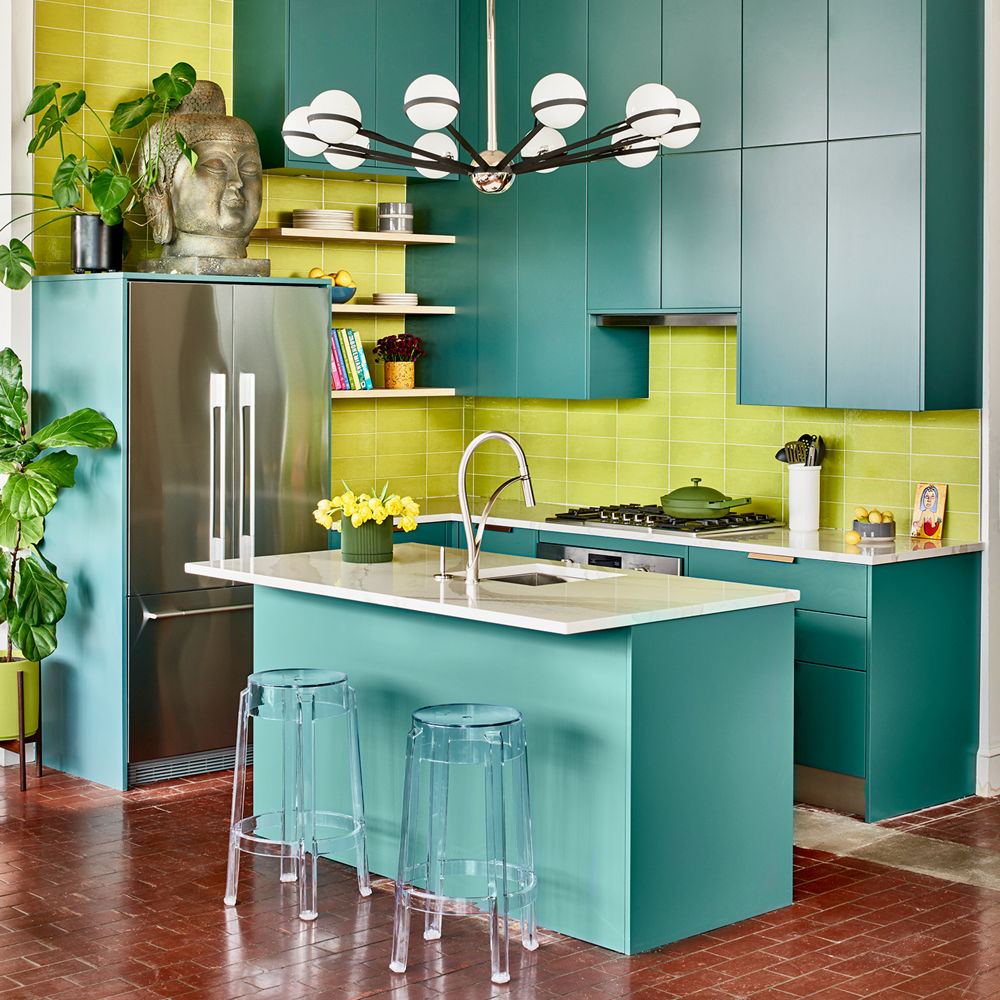 Teal kitchen featuring an island and perimeter with Cambria Brittanicca Warm quartz countertops.