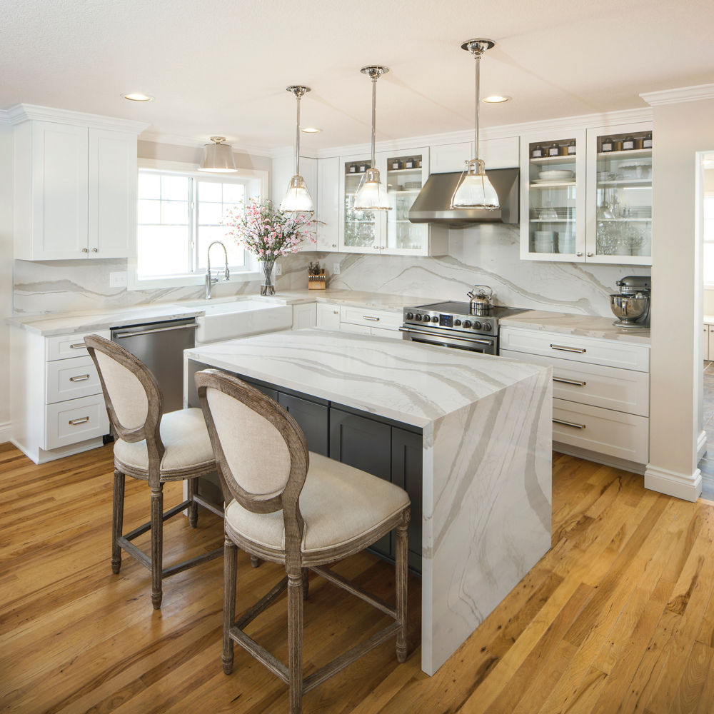 An after image of a kitchen featuring counters and an island with Cambria Brittanicca Warm quartz countertops.