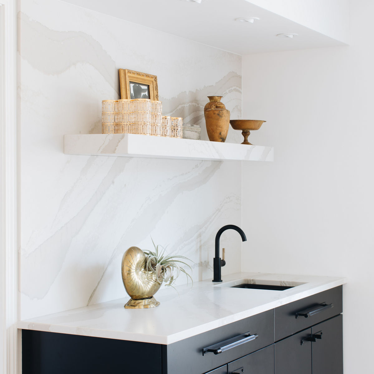 A clean bar area from House of Hipsters featuring Cambria Brittanicca Warm Matte countertops