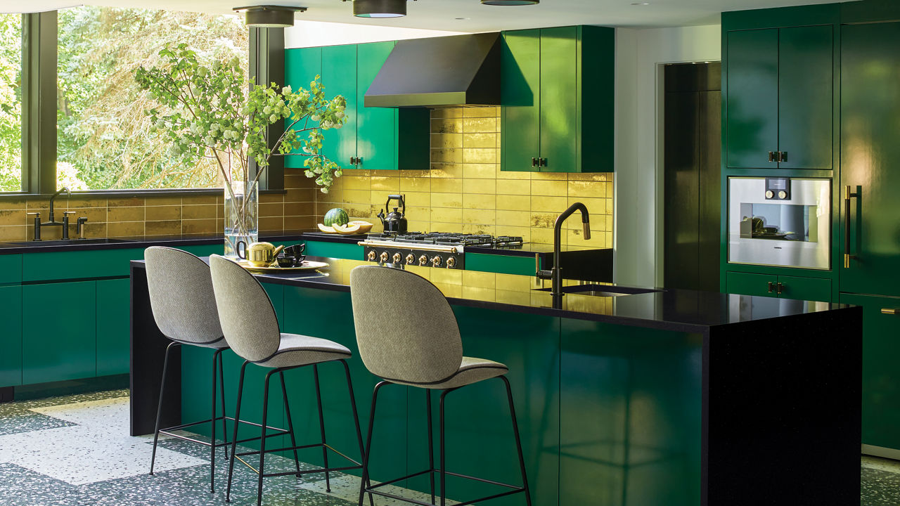 Designer : A. Villalobos 
Instagram: @avillalobosdesign
â ¢Kitchen cabinets are painted in â  Chrome Greenâ   by Benjamin Moore in High gloss 
â ¢Countertop are Black Pool by Cambria 
â ¢Stove is by La Cornue 
â ¢Backsplash is Elenco Gold Tile by Ann Sacks
â ¢Light over counter is name â  Porteâ   by Urban Electric 
â ¢Flooring is custom terrazzo tiles by A. Villalobos through Concrete Collaborative 
â ¢Set of Plates over the stove are Portuguese Majolica through Christieâ  s 
â ¢Counter stool is The Beetle by Gubi