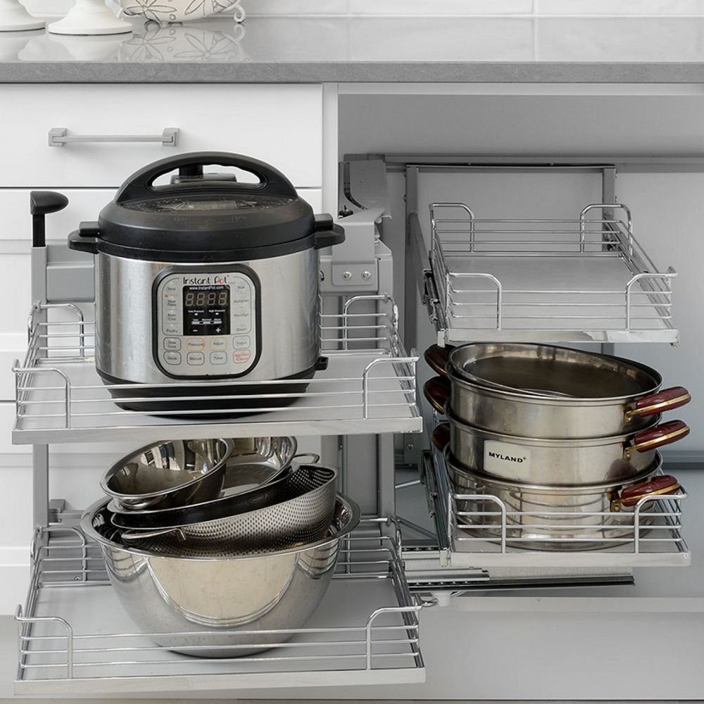 A kitchen featuring smart cabinet organizers, gray Cambria Carrick quartz countertops, and a subway tile backsplash.